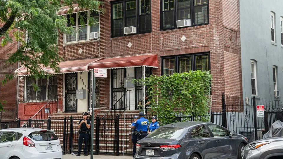Police stand outside Islam's home in the Bronx. - Timothy Fadek for CNN