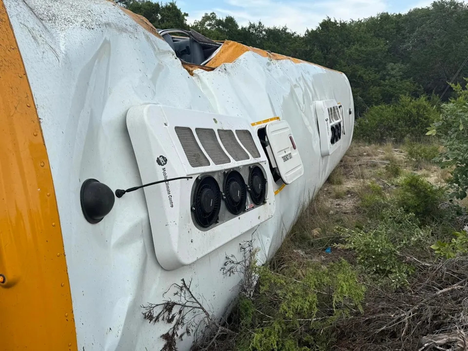 Travis County emergency services - PHOTO: A school bus carrying over 40 children and one adult on the first day of the new school year rolled over onto its side near Austin, Texas, on Wednesday, leaving 12 injured, officials said.