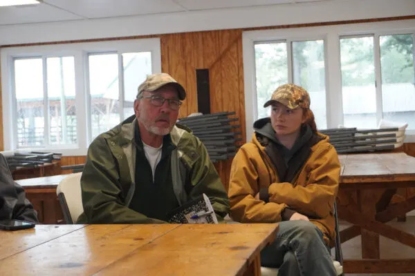 Mark Sultenfuss, who farms in the Centreville area, discusses his concerns about solar energy on Maryland farmland, as daughter Sophie looks on. (Photo by Christine Condon/Maryland Matters)