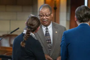  State Sen. Victor Rountree of Bellevue, center, talks with State Sens. Danielle Conrad and George Dungan, both of Lincoln. April 10, 2025. (Zach Wendling/Nebraska Examiner)