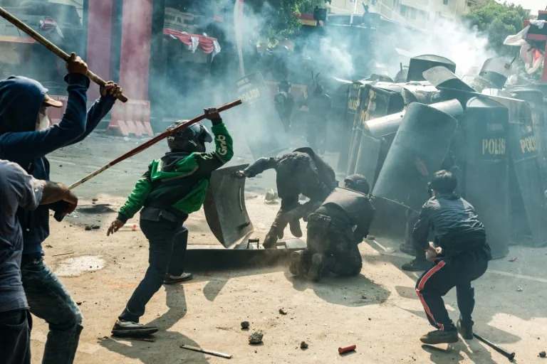 Indonesia police fire tear gas at protesters after driver's death