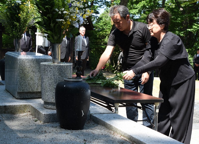 慰霊碑に献花する参加者＝岩手県雫石町で2025年7月30日午前10時3分、山田英之撮影