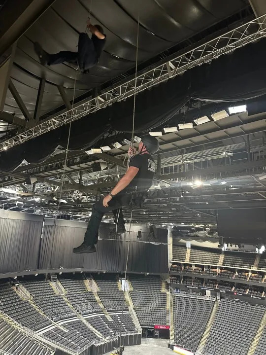 SWAT officers hanging from ropes during training
