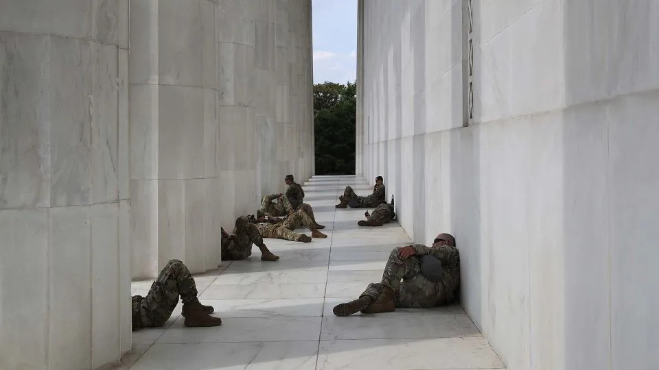 National Guard members take a break from the heat at the Lincoln Memorial while protesters demonstrate against police brutality and racism in Washington, DC, on June 6, 2020. - Win McNamee/Getty Images