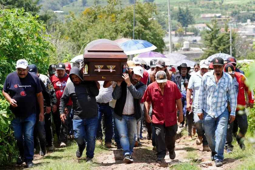 Zinapecuaro, Michoacan - July 26: Residents of the Huajumaro de Guadalupe community bid their final farewell to Jaime Alanis Garcia, a Mexican man killed in a raid by Immigration and Customs Enforcement (ICE) agents in Camarillo, California, on Saturday, July 26, 2025 in Huajumaro de Guadalupe, outside of Zinapecuaro, Michoacan, Mexico. On July 10, federal immigration agents raided two cannabis greenhouse operations owned by Glass House Farms, setting off an intense, hours-long standoff between federal agents and protesters outside the company&#39;s Camarillo site. Alanis Garcia was fatally injured when he climbed atop a greenhouse and fell 30 feet while fleeing immigration agents at Glass House, his family said. (Juan Jose Estrada Serafin / For The Times)