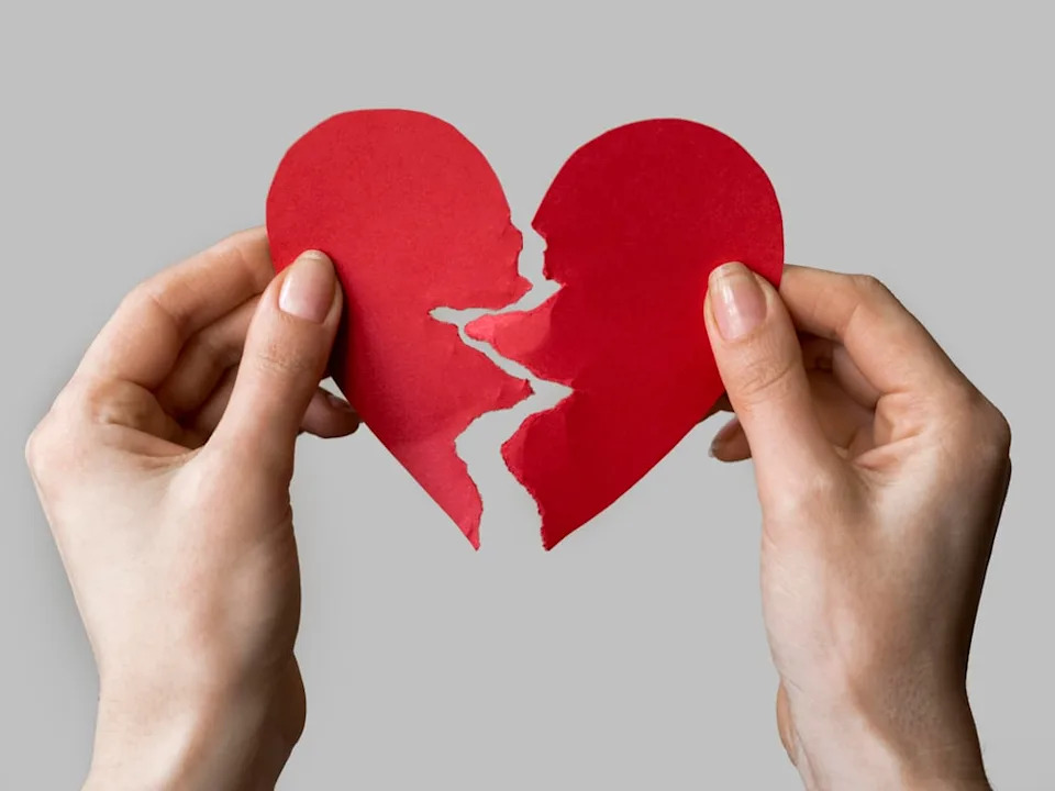 Paper heart torn in half.