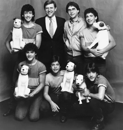 Jose Menendez, top row, second from left, is pictured with former members of Menudo in 1983, including Roy Rossello, bottom right. / Credit: Sony Music/RCA Records