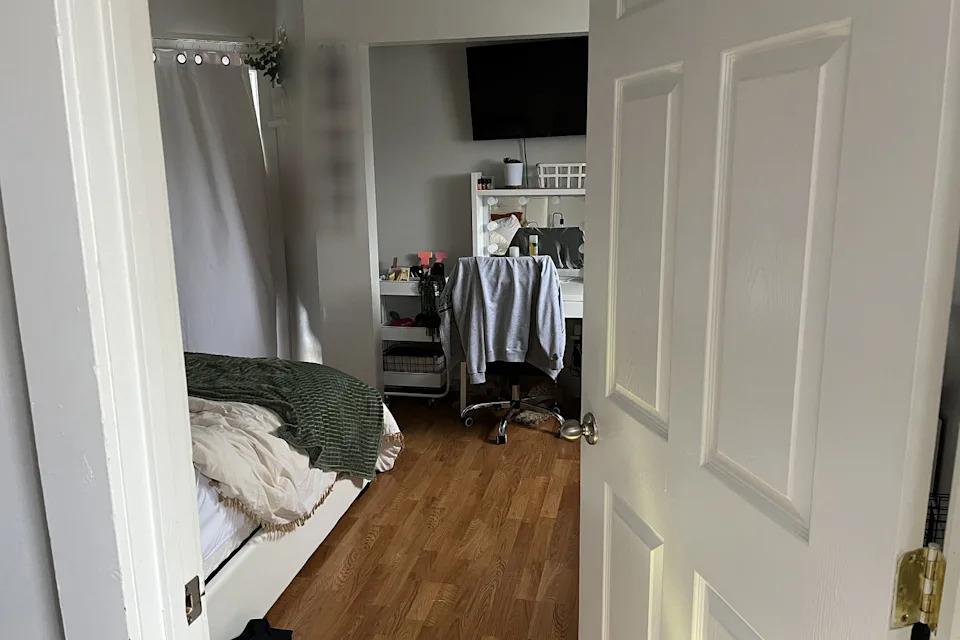 Leading into empty room, bed on left, blurred photos on wall but no sign of blood, etc. (Moscow Police Department)