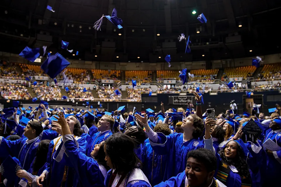 Graduates toss their caps during the Martin Luther King Jr. Magnet High School commencement ceremony at Municipal Auditorium in Nashville on May 17, 2023.
