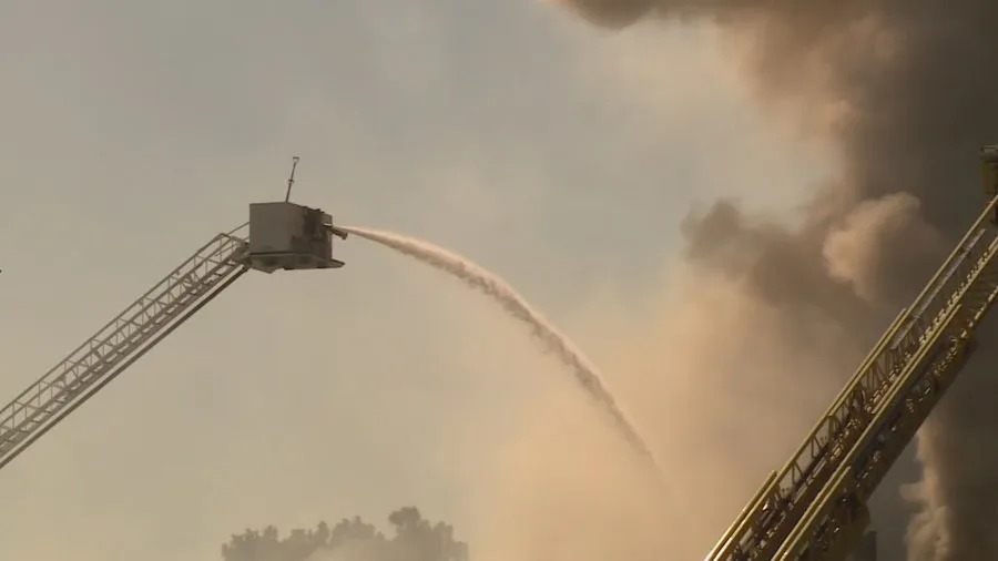 Clark County fire crews battle a large blaze at a business complex across the street from the UNLV campus on Maryland Parkway, near Tropicana Avenue on July 25, 2025. (KLAS)