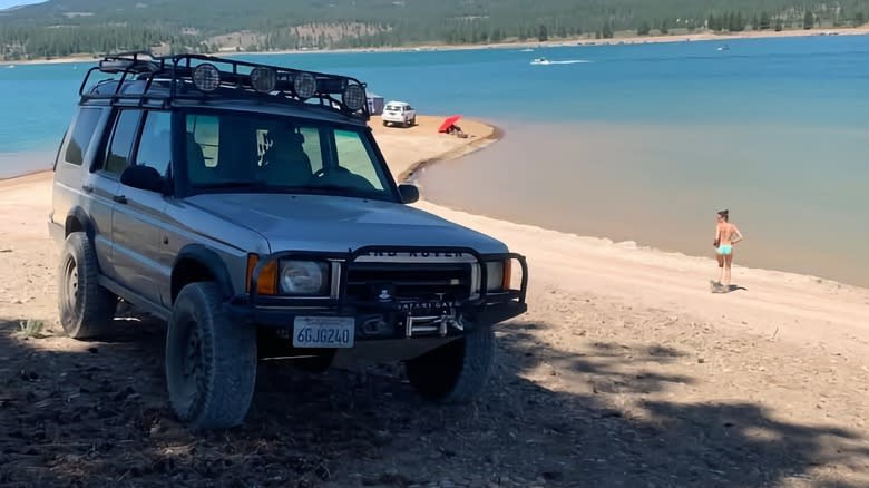 2000 Land Rover Discovery on a lake-front beach