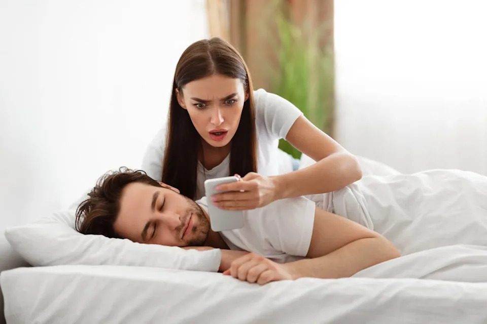 Couple laying in bed together.