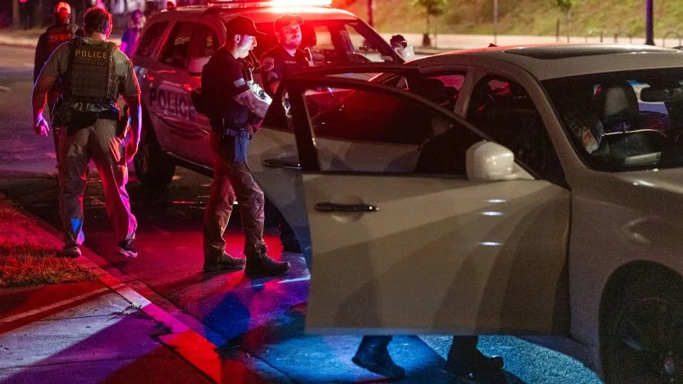 Metropolitan Police Department officers and Homeland Security Investigations special agents search a vehicle on Thursday. - Eric Lee for CNN