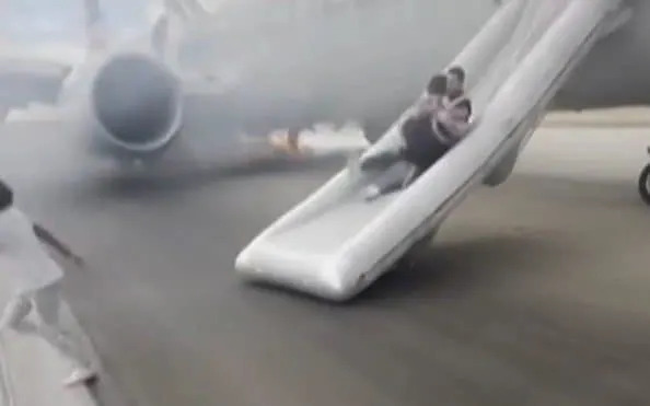 Passengers escape from an American Airline flight after a tyre blow-out at Denver International Airport in Colorado
