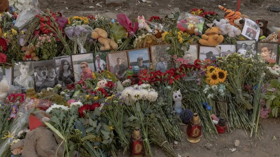 Flowers, children's toys and victims' portraits form a makeshift memorial at the site of a residential building destroyed by a Russian missile strike in Kyiv, pictured on August 5. - Roman Pilipey/AFP/Getty Images