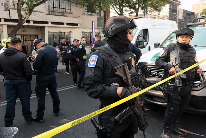 Police officers stand guard near the crime scene of the killing of Jose Munoz and Ximena Guzman in Mexico city on May 20, 2025. / Credit: VALENTINA ALPIDE/AFP via Getty Images