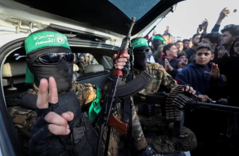 Palestinian Hamas terrorists parade as they prepare to hand over hostages kidnapped during the October 7, 2023, attack on Israel by Hamas, to the Red Cross as part of a ceasefire and a hostages-prisoners swap deal between Hamas and Israel, in Gaza City, January 19, 2025. (credit: Dawoud Abu Alkas/Reuters)