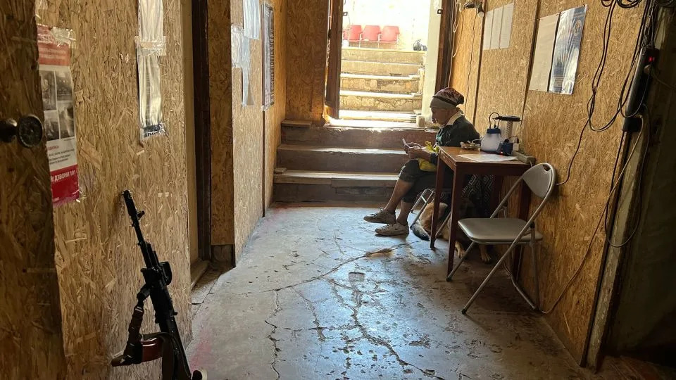 Orikhiv citizen Liudmyla sits in the last operating post office in Orikhiv. The woman lives alone with two dogs and is not going to leave. "I don't have anywhere to go. I'll just stay here and never go anywhere else". - Daria Tarasova-Markina/CNN