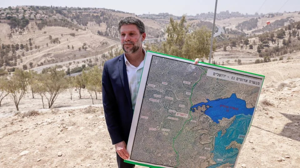 Israeli far-right Finance Minister Bezalel Smotrich holds a map of an area near the settlement of Maale Adumim in the occupied West Bank on August 14. - Menahem Kahana/AFP/Getty Images