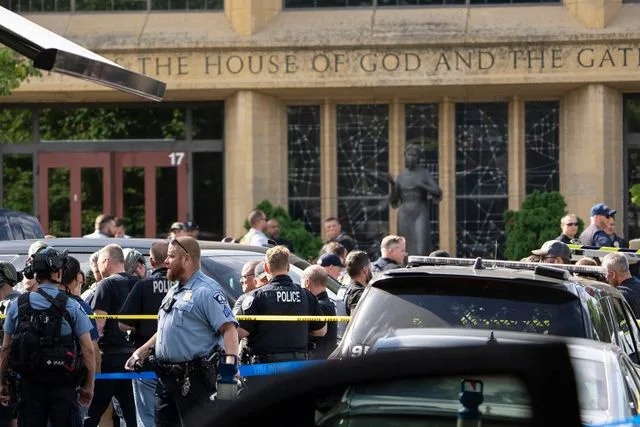 Renee Jones Schneider/The Minnesota Star Tribune via Getty First responders crowd the street in front of Annunciation Catholic Church on Wednesday