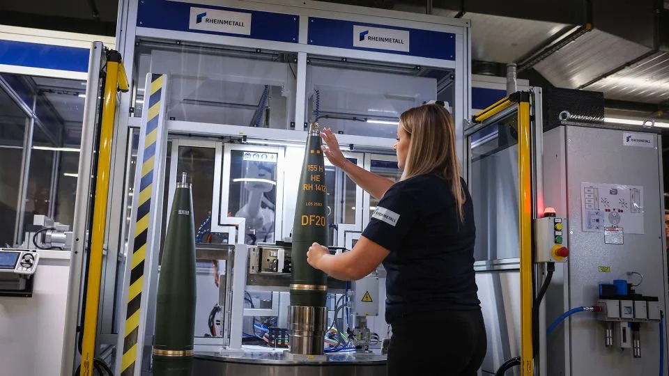 An employee works in the shell marking of 155mm artillery ammunition, the NATO standard. - Ronny Hartmann/AFP/Getty Images