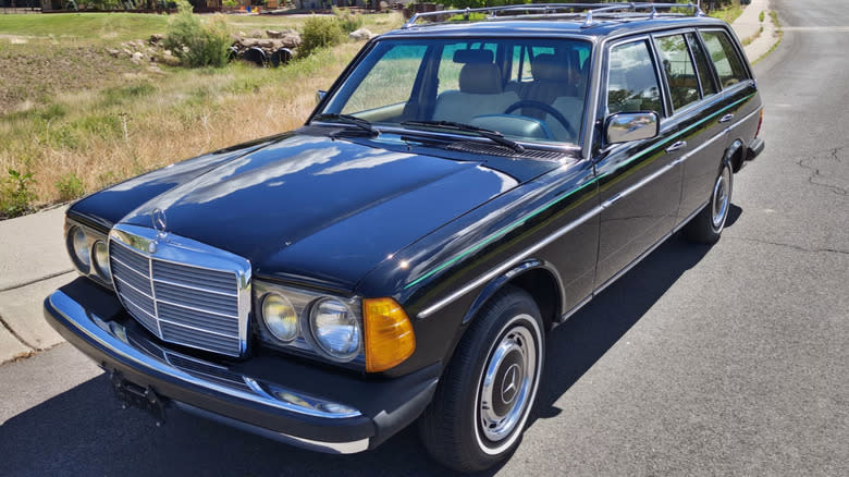 A black 1984 Mercedes-Benz 300TD Wagon parked on the side of the road