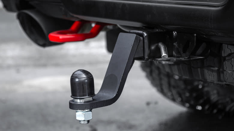 A black truck with trailer hitch ball installed