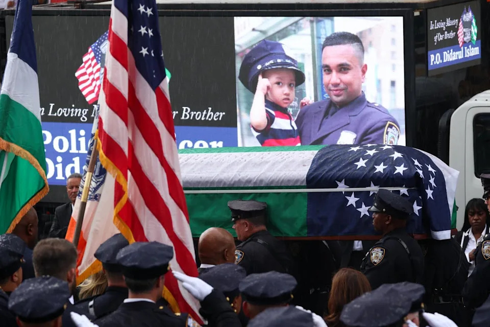 Police officers carry the casket of slain NYPD officer Didarul Islam to a hearse during Islam's funeral services in the Bronx (AFP via Getty Images)