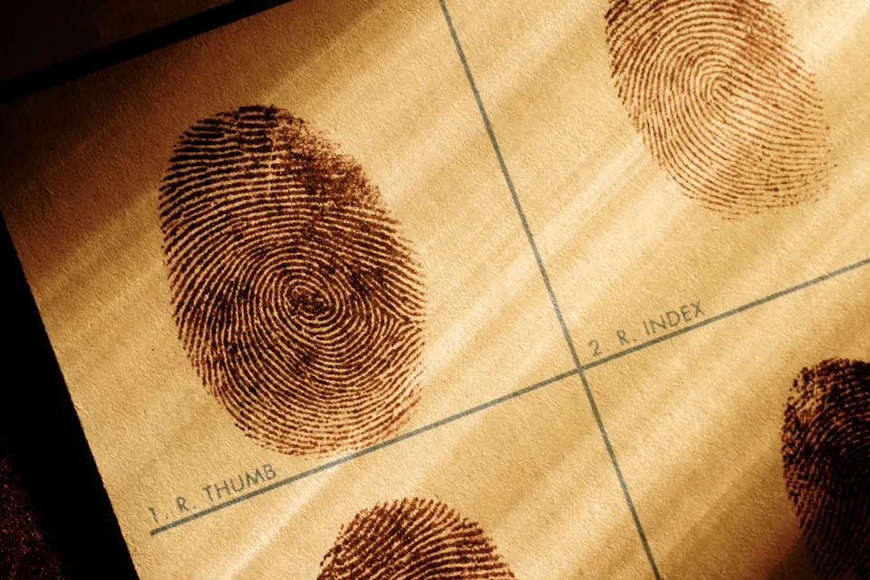 Close-up of inked fingerprints on a fingerprint card, labeled for the right thumb and index finger