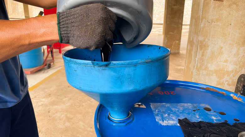 Used engine oil being stored in a barrel.