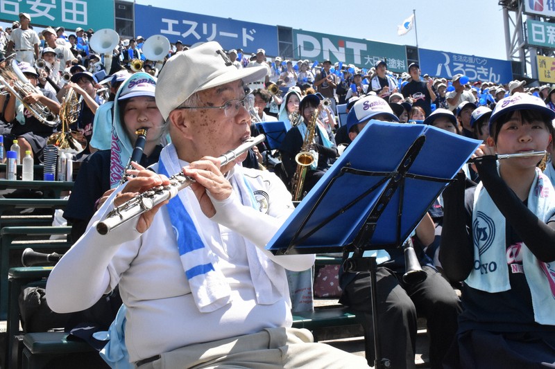 三塁側アルプス席で日大三の吹奏楽部員に交じってフルートを吹く清水幸さん＝阪神甲子園球場で2025年8月19日午前11時5分、来住哲司撮影