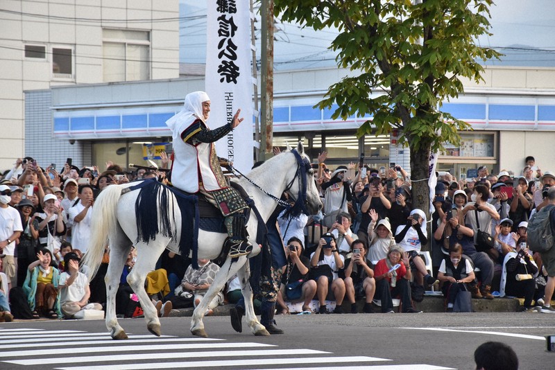 上杉謙信に扮（ふん）した俳優の松平健さんに観客たちは手を振ったり、カメラを向けたりしていた＝上越市で2025年8月23日午後5時48分、戸田紗友莉撮影