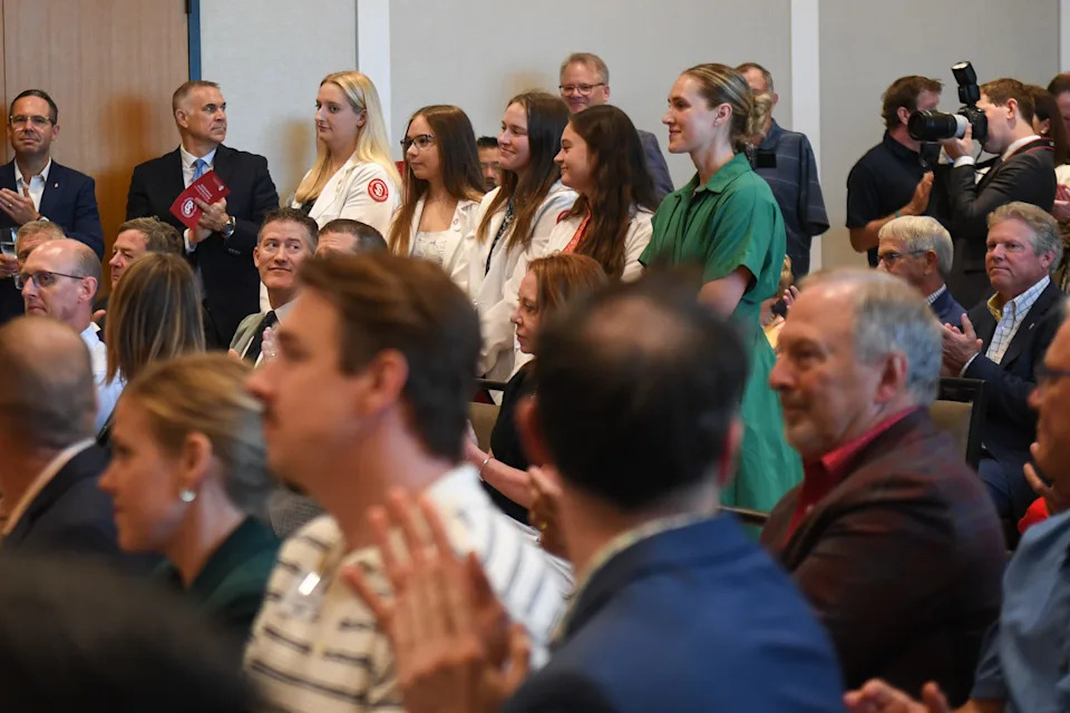 University of South Dakota medical students stand up to be recognized during the Sanford School of Medicine announcement on Thursday, Aug. 14, 2025, at Canopy by Hilton in Sioux Falls.