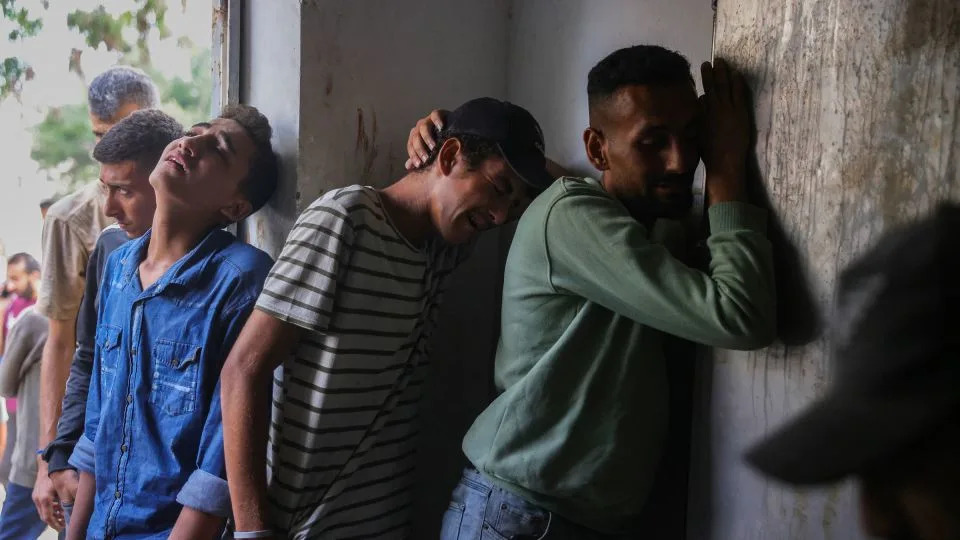 Palestinians mourn outside the Al-Shifa Hospital morgue, where the bodies of people killed while seeking aid the previous day were brought, in Gaza City on July 31. - Bashar Taleb/AFP/Getty Images