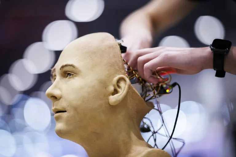 A man works on the electronics of Jules, a humanoid robot from Hanson Robotics using AI, at the recent International Telecommunication Union AI for Good Global Summit in Geneva (Valentin FLAURAUD)