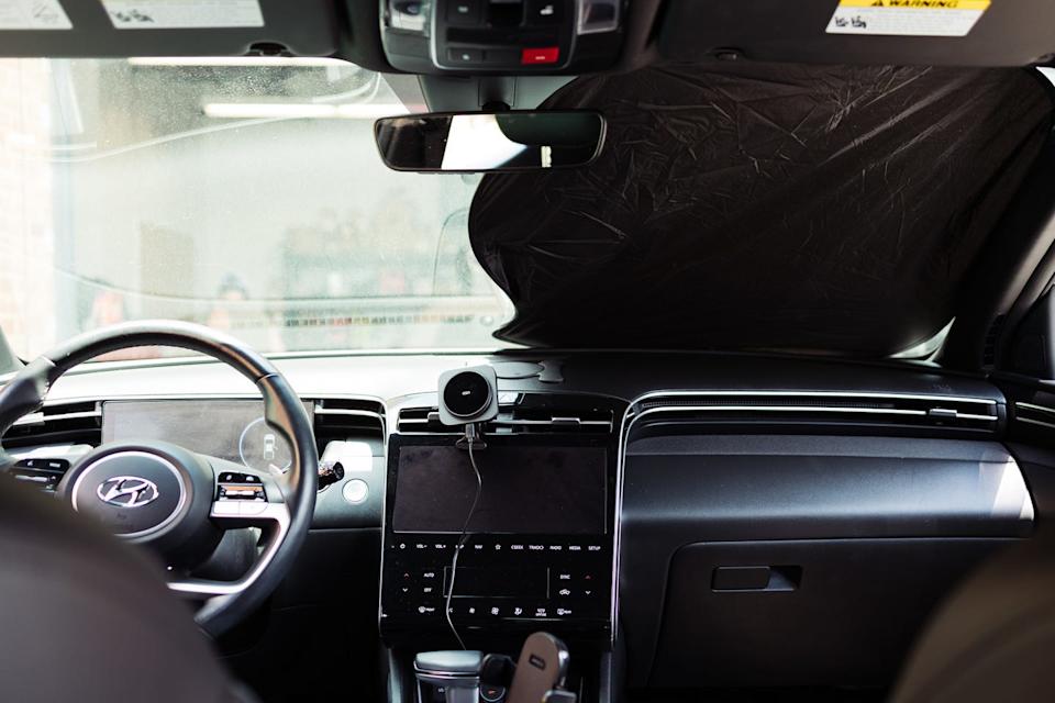 a side by side comparison of a vehicle interior with a sunshade installed versus uninstalled