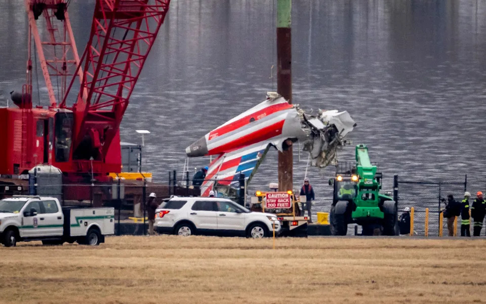 Plane wreckage is removed from the Potomac River after the crash