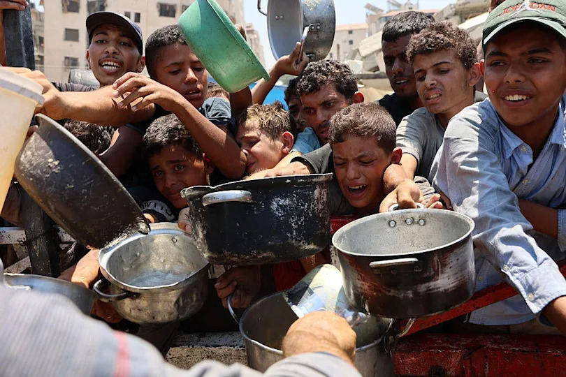 Palestinians crowd at a lentil soup distribution point in Gaza City, in the northern Gaza Strip, July 27, 2025. / Credit: OMAR AL-QATTAA/AFP/Getty