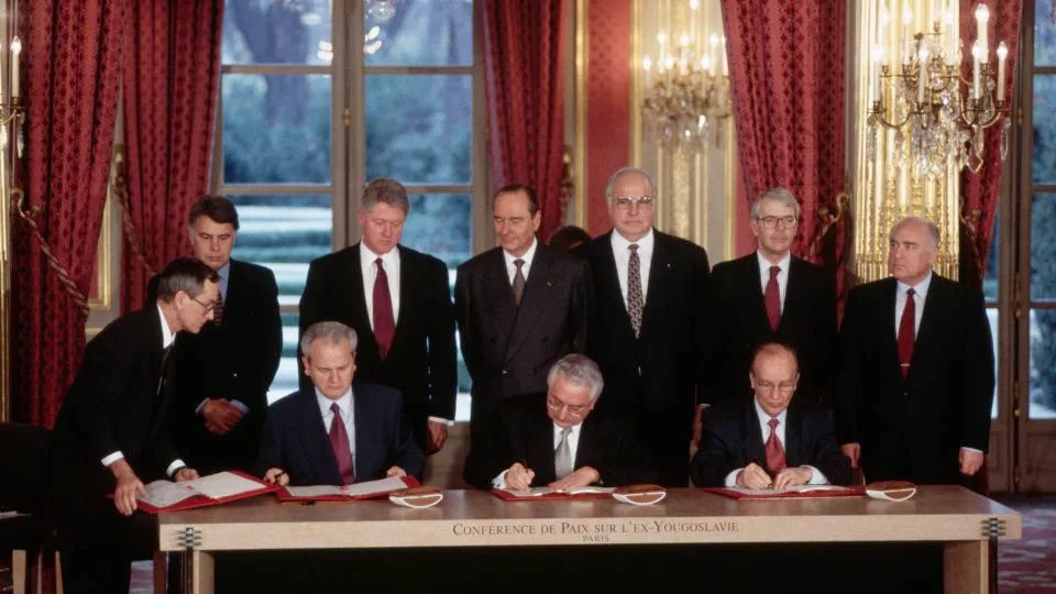 Leaders of six nations look on as the presidents of Serbia, Croatia and Bosnia sign the Dayton Peace Accords at the Élysée Palace in France, December 1995. - Peter Turnley/Corbis/Getty Images