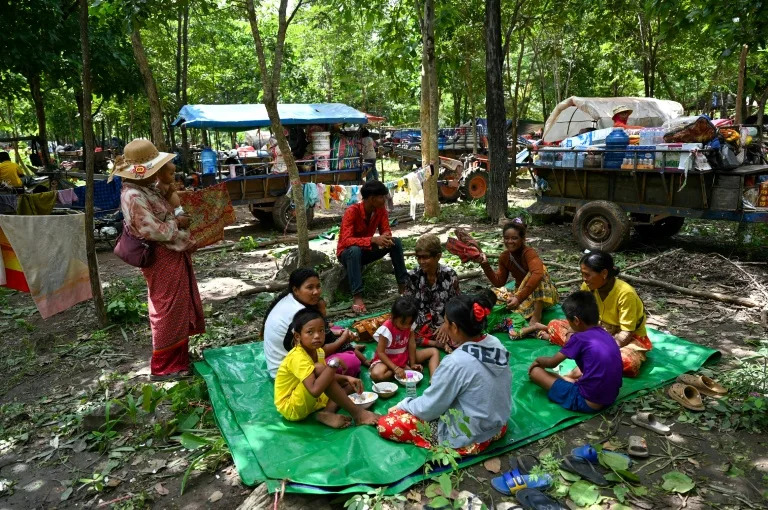 People who fled their homes near the Cambodia-Thailand border rest on the grounds of a pagoda in Oddar Meanchey province (TANG CHHIN Sothy)