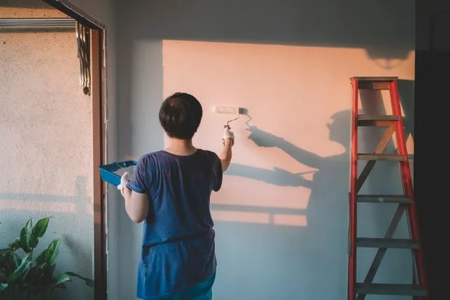 Getty Stock photo of a woman painting her apartment