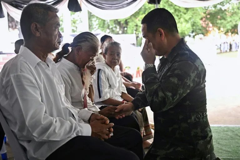 A soldier consoles the parents of Thai soldier Theerayuth Krajangthong, 22, who died in clashes with Cambodia, during funeral rites (Lillian SUWANRUMPHA)