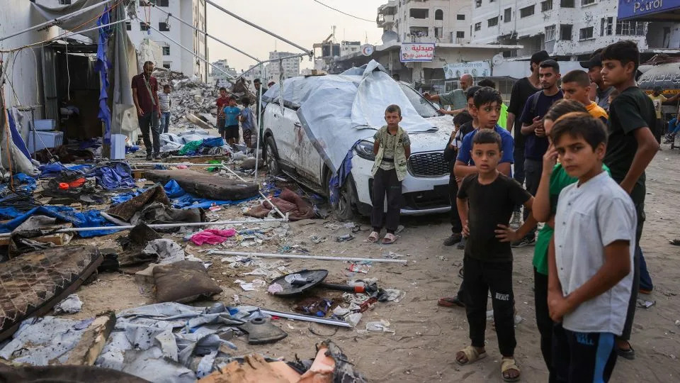 Palestinians stand near the destroyed Al Jazeera tent at Al-Shifa Hospital in Gaza City on August 11, 2025, following an overnight strike by the Israeli military. - Bashar Taleb/AFP/Getty Images