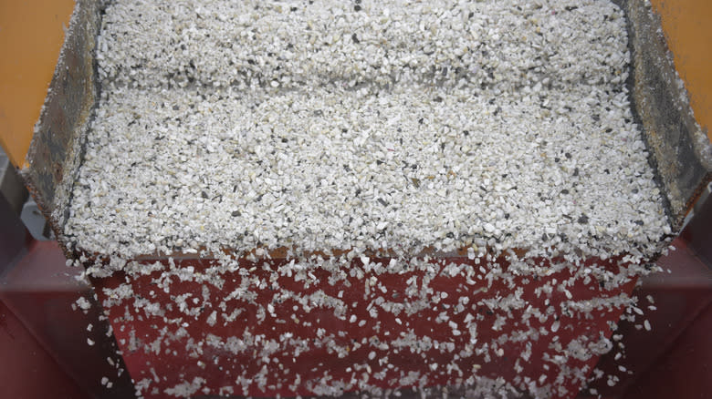Lithium ore falls through a separation machine during the extraction process at a lithium mine site in Australia.