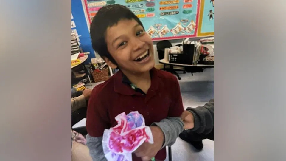 Bryan Vasquez smiling in a classroom