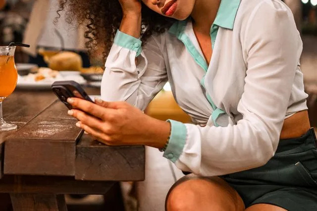 Getty Stock photo of a woman upset at a dinner party