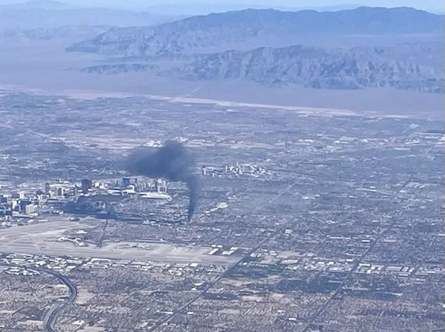 Overhead view from a plane showing a large blaze at a business complex across the street from the UNLV campus on Maryland Parkway, near Tropicana Avenue on July 25, 2025.
