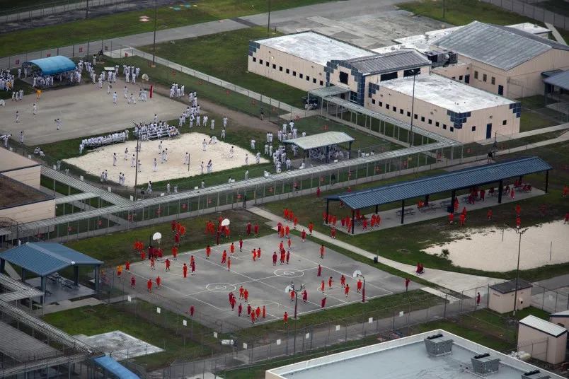 MIAMI, FLORIDA – JULY 4: In an aerial view from a helicopter, detainees are seen at Krome Detention Center run by United States Immigration and Customs Enforcement on July 4, 2025 in Miami, Florida. U.S. President Donald Trump was present at the opening of the nearby “Alligator Alcatraz”, a 5,000-bed facility, located at an abandoned airfield in the Everglades wetlands, part of his expansion of undocumented migrant deportations. (Photo by Alon Skuy/Getty Images)