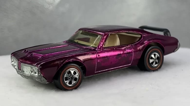 The 1971 Olds 442 Hot Wheels car in magenta with a white background.