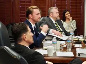State Superintendent Ryan Walters sits at the head of the table at a meeting of the Oklahoma State Board of Education on Jan. 28 flanked by former Oklahoma State Department of Education general counsel Michael Beason, front, and board counsel Chad Kutmas, back. (Photo by Nuria Martinez-Keel/Oklahoma Voice)